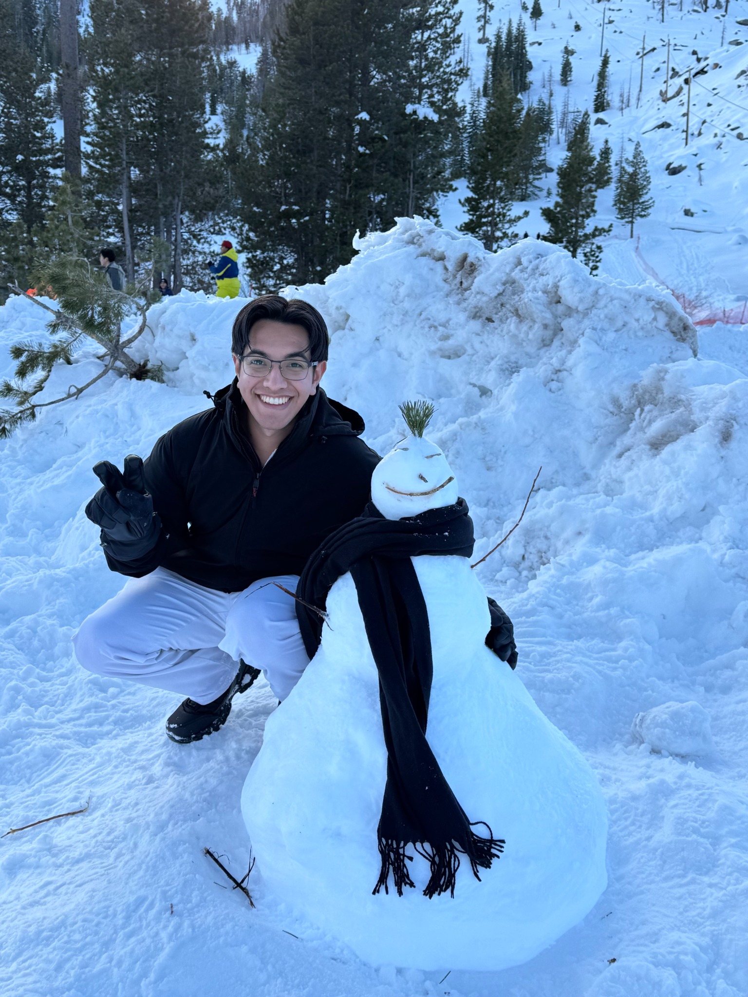 Juan outdoors with a snowman